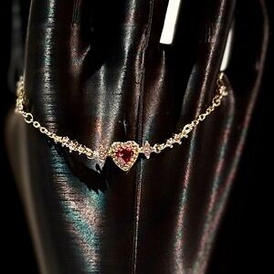 Elegant Gold Heart Bracelet with Red Gemstone